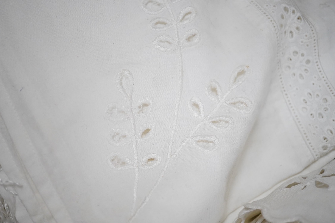 Two boxes of mixed white on white embroidered linen and cotton table cloths etc, some with crochet edging and cut work.